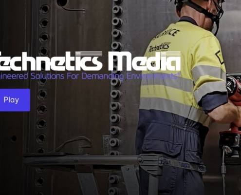 image: a construction worker uses a massive power drill to secure rivets - text: Technetics Media, play
