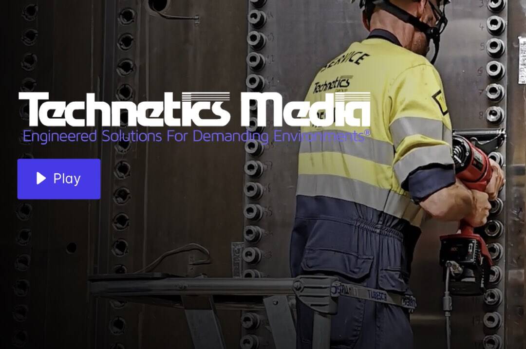 image: a construction worker uses a massive power drill to secure rivets - text: Technetics Media, play